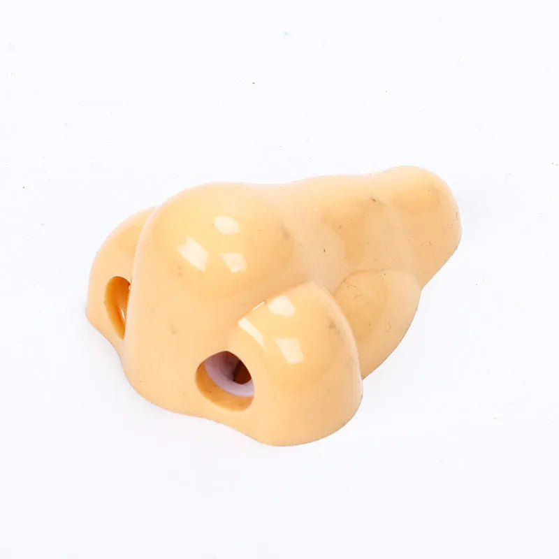 Flesh colour plastic geometry-shaped pencil sharpener with large sharpening holes.