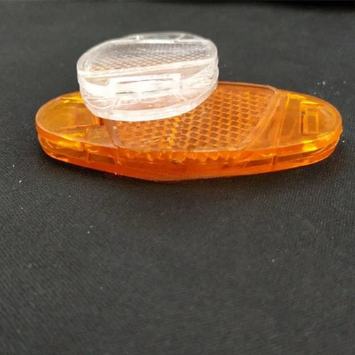White and yellow plastic bicycle spoke reflectors for wheel safety visibility