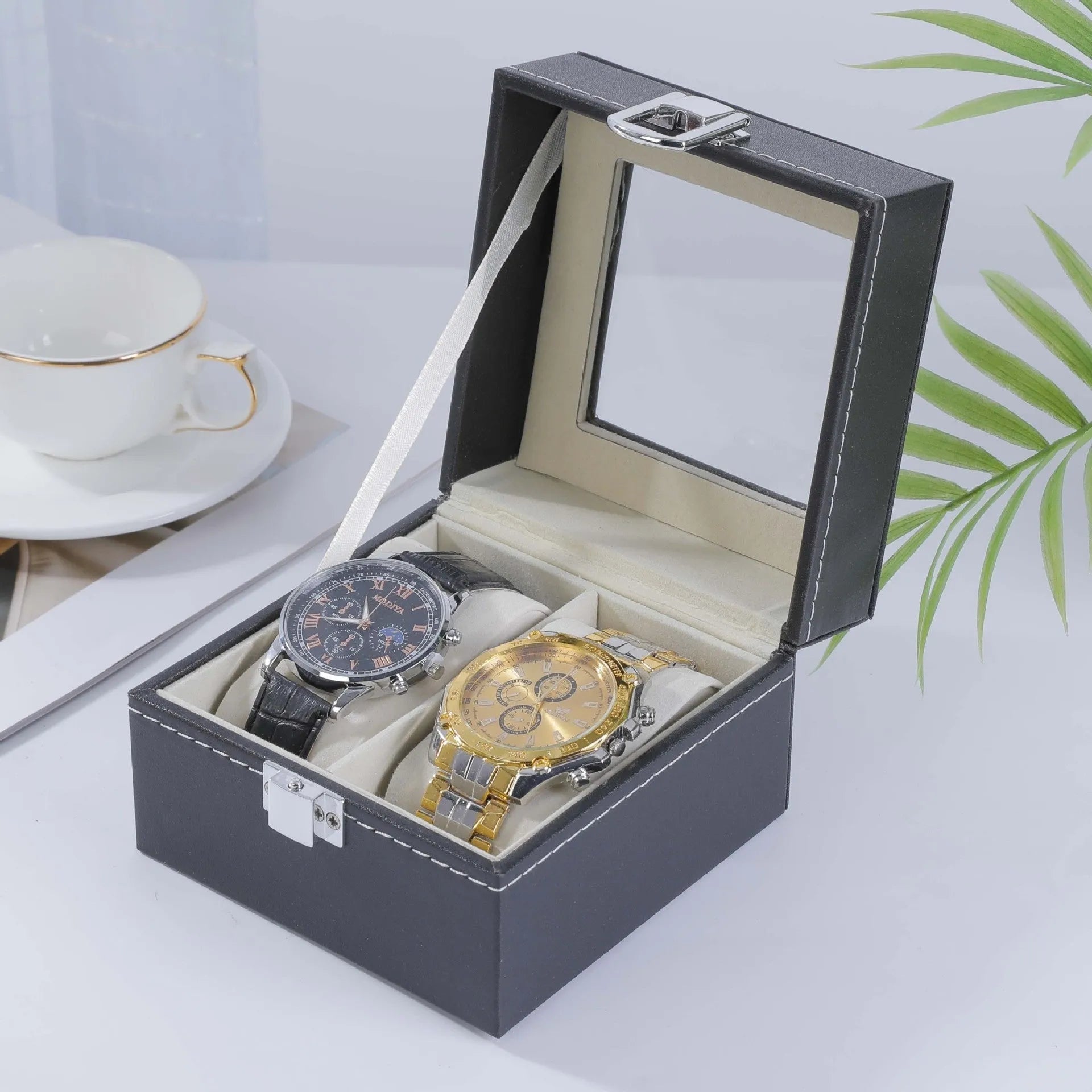 Grey leather watch storage box with a transparent dust cover, showing internal watch slots.
