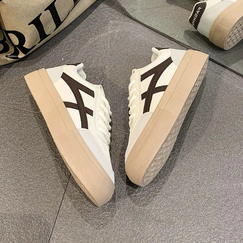 Blue and brown low-top casual board shoes with round toe and flat rubber sole.