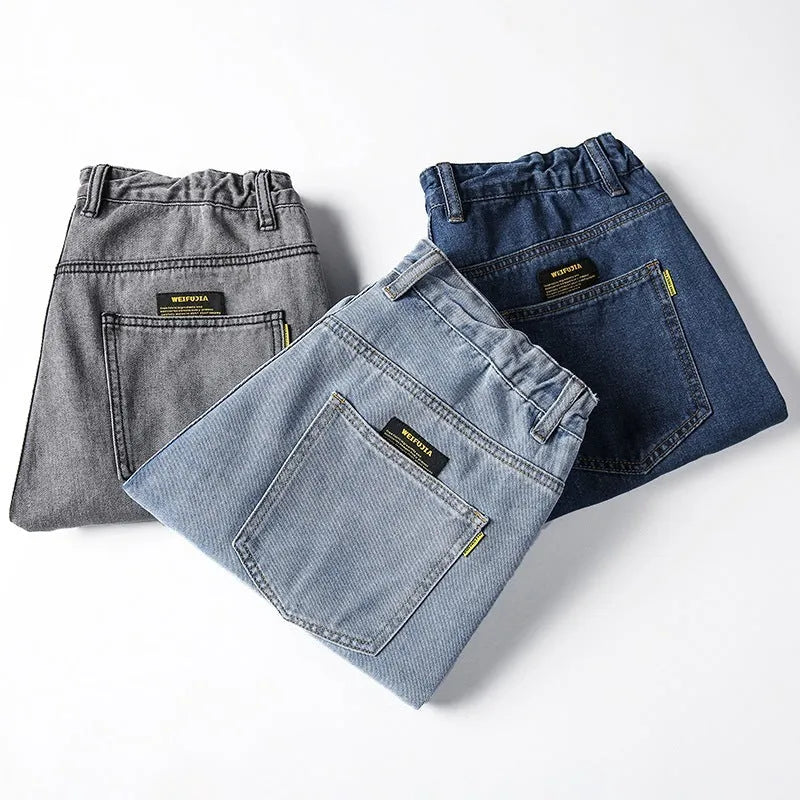 Men's loose straight blue jeans with mid waist and zipper fly on hanger
