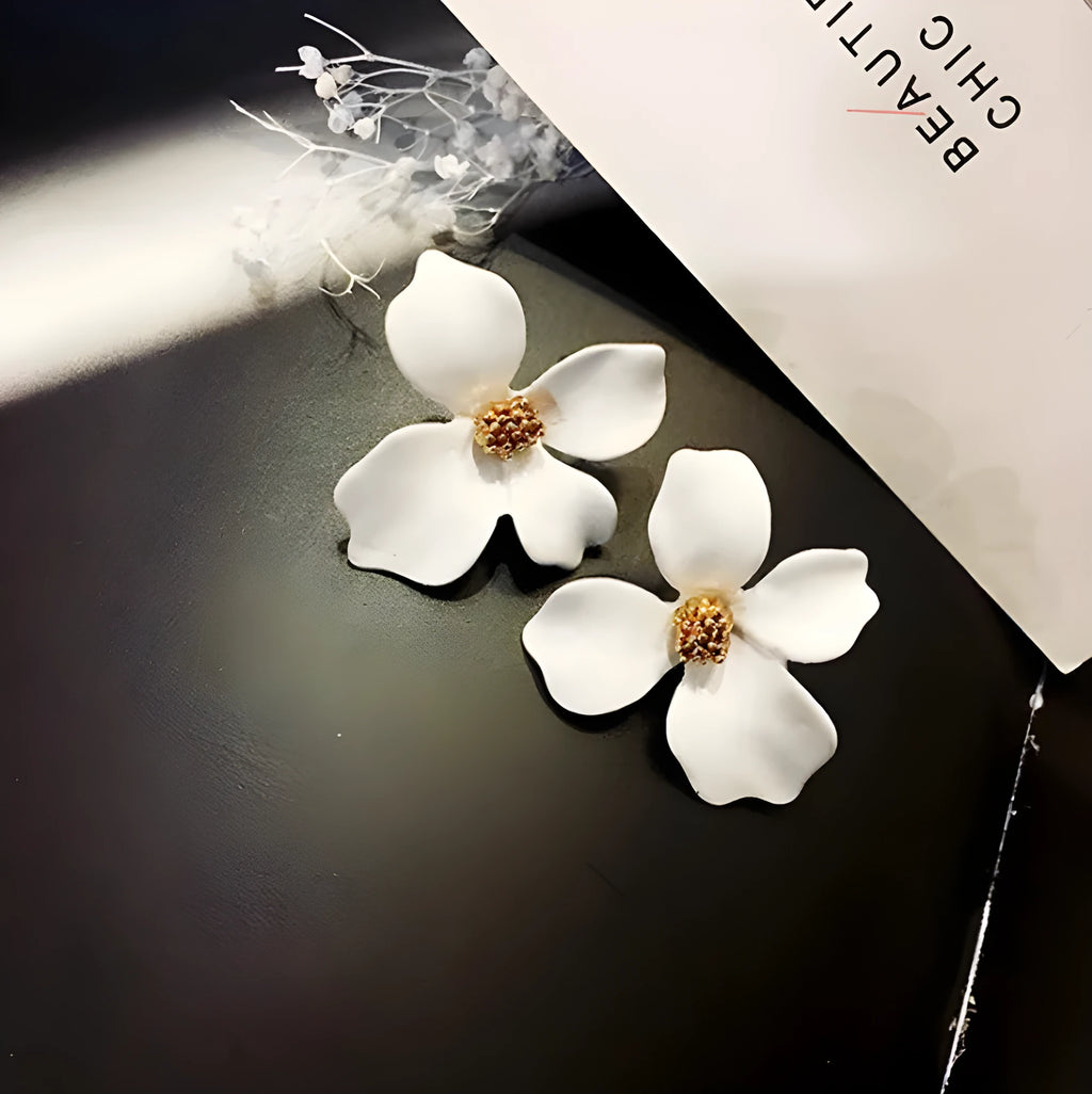 A pair of small floral-shaped stud earrings in alloy, shown in pink and white colour options.