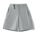 Man wearing khaki 3D cut sports shorts with four-way stretch fabric during a run.