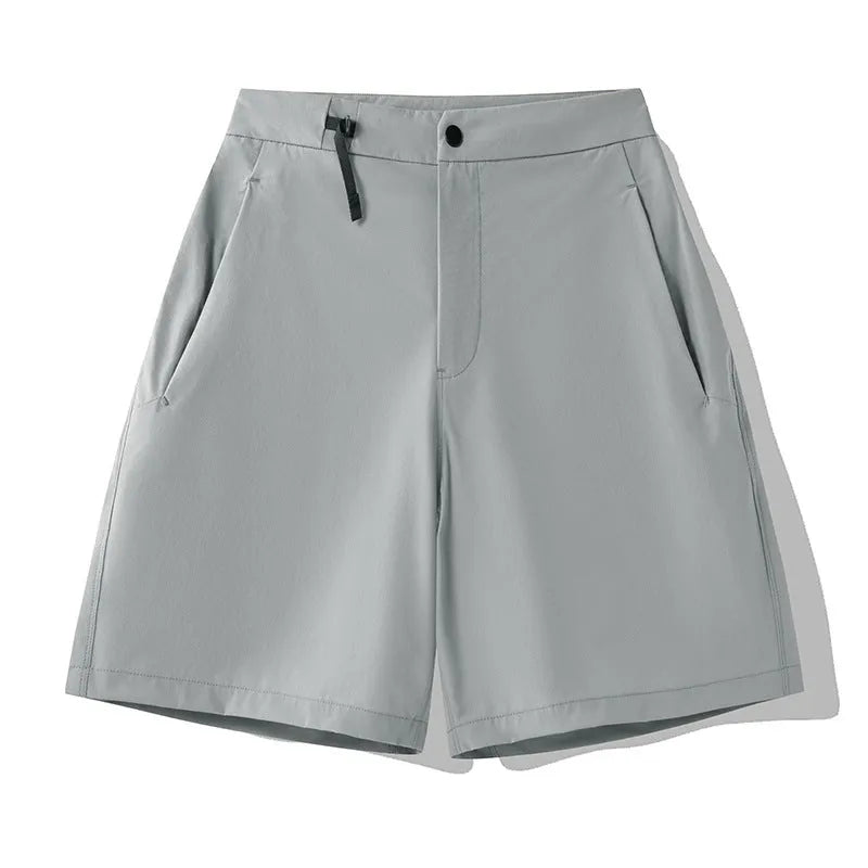 Man wearing khaki 3D cut sports shorts with four-way stretch fabric during a run.
