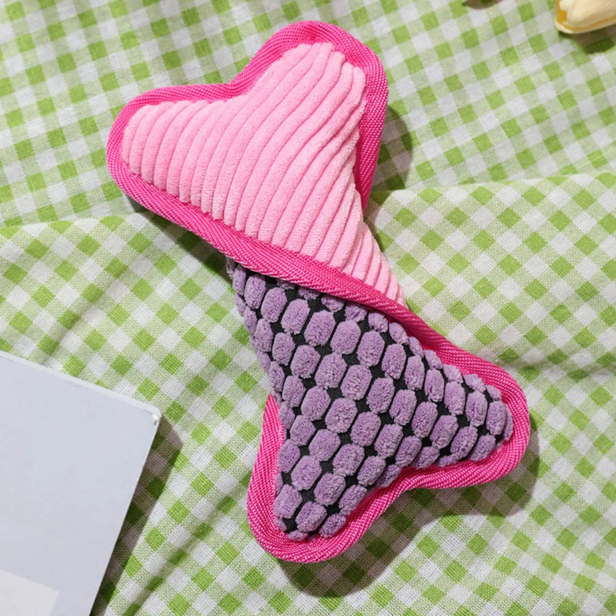 Blue teddy dog toy shaped like a bone with a corn fleece lining and integrated sound module