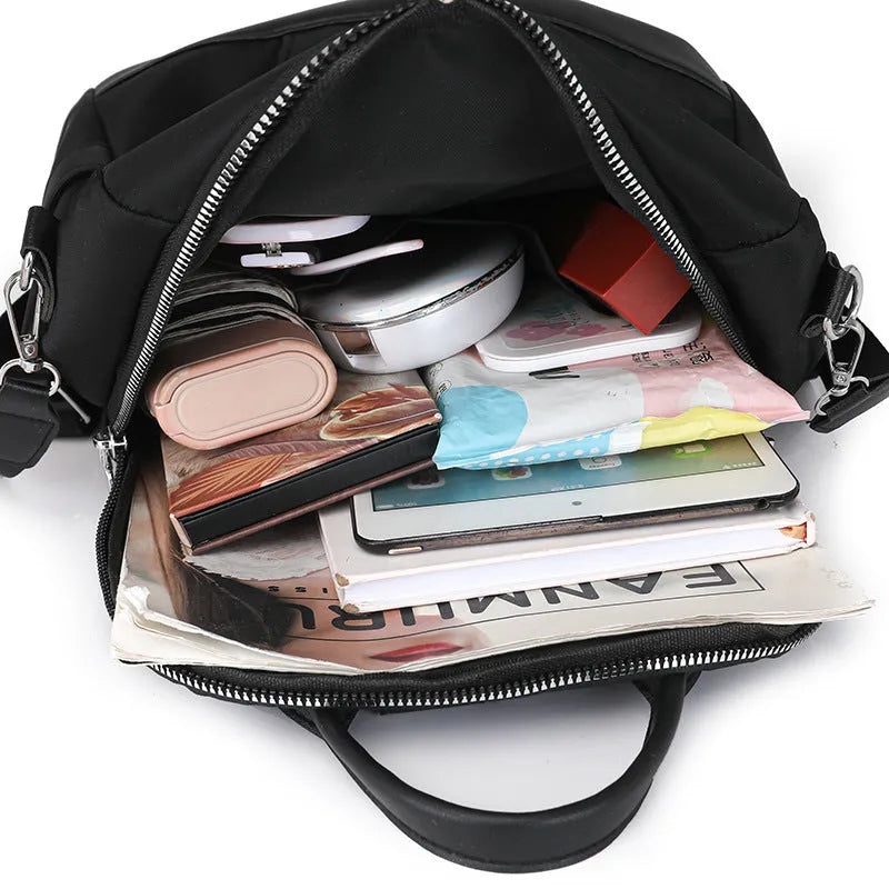 Soft black PU backpack showing three-dimensional front pocket and large main compartment.