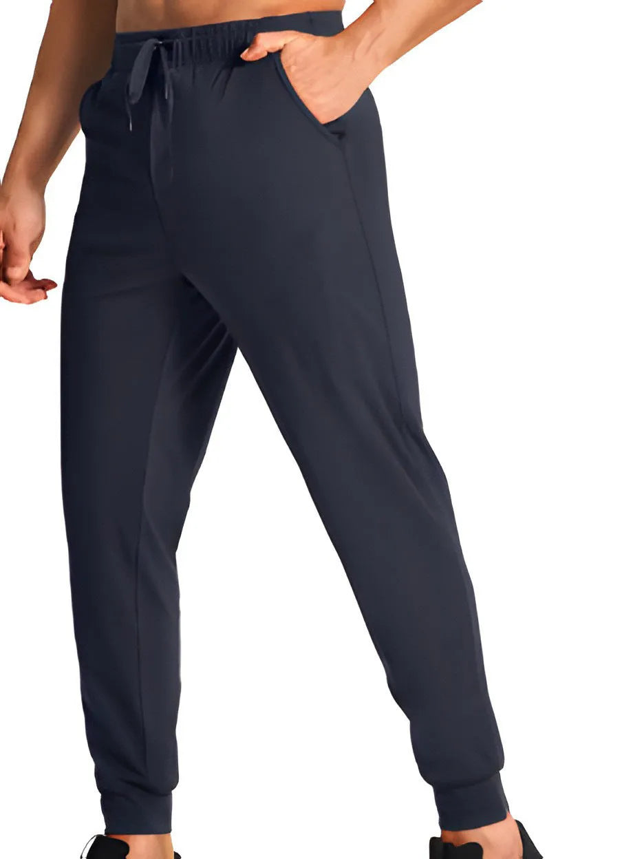 Men's loose fit solid colour casual trousers in polyester fabric on a hanger