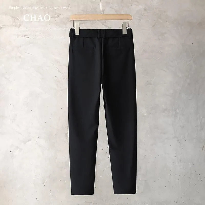 Boy wearing slim straight grey wool blend trousers in a business casual style.