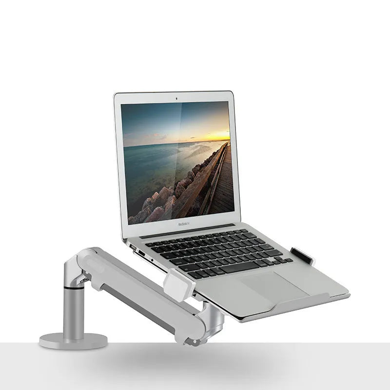 Silver aluminium laptop stand with adjustable air pressure arm bracket holding a MacBook notebook.