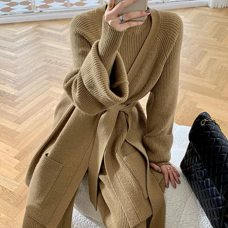 Women's apricot knitted three-piece set with leather stitch detail on cardigan, wide-leg trousers, and top.