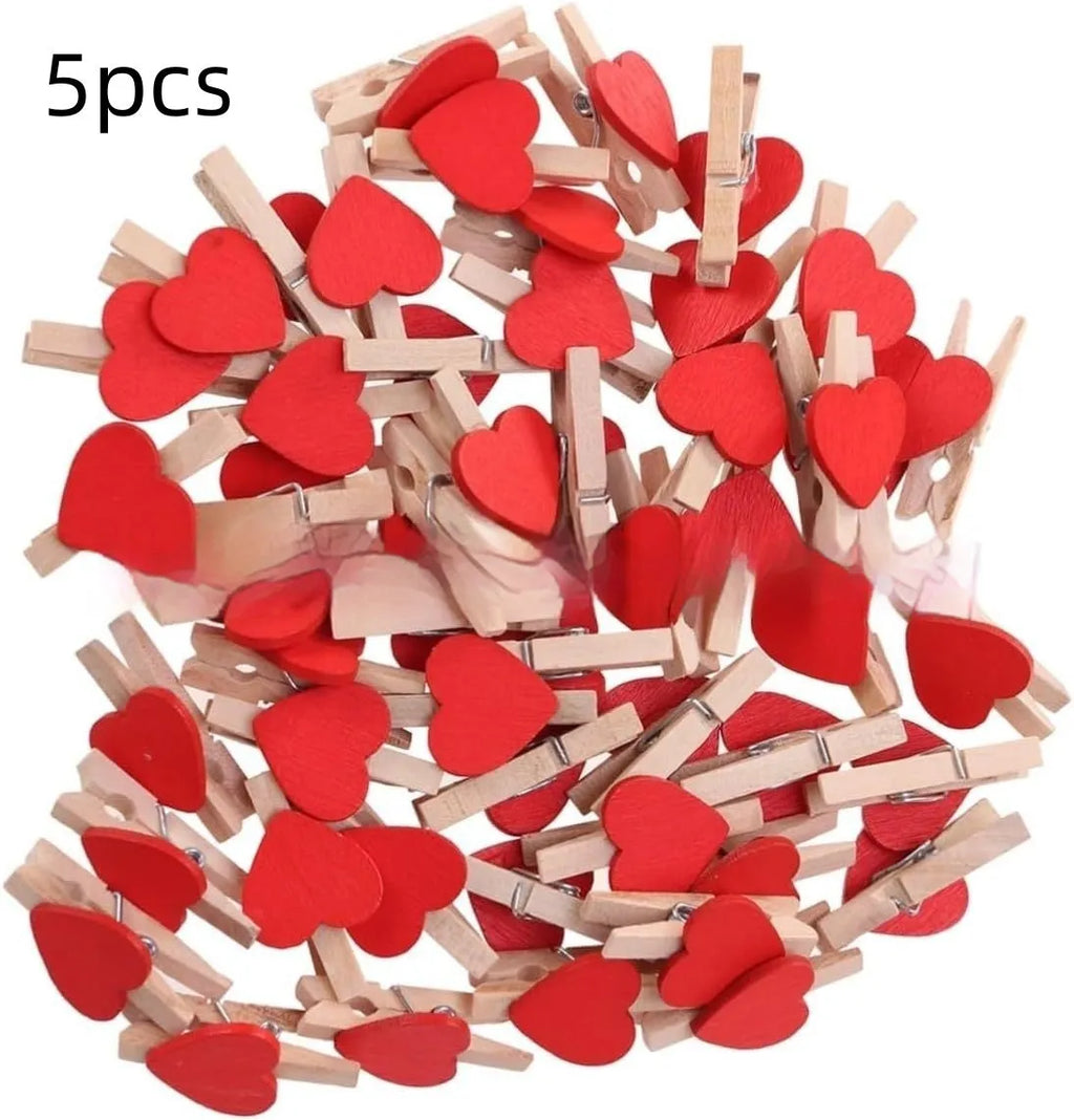 Five handmade solid wood heart-shaped hair clips in different colours on wooden surface