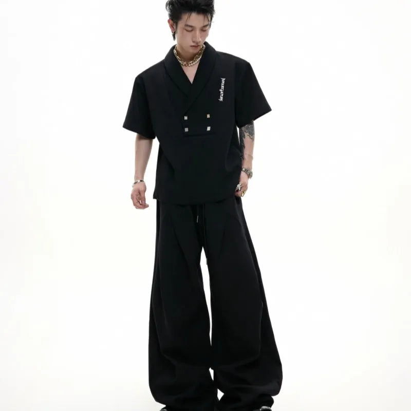 Men's dark grey V-neck cotton sports suit jacket with padded shoulders and matching shorts.