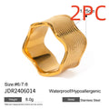 Stainless steel wide band ring with a geometric wave pattern, shown in an electroplated colour option.