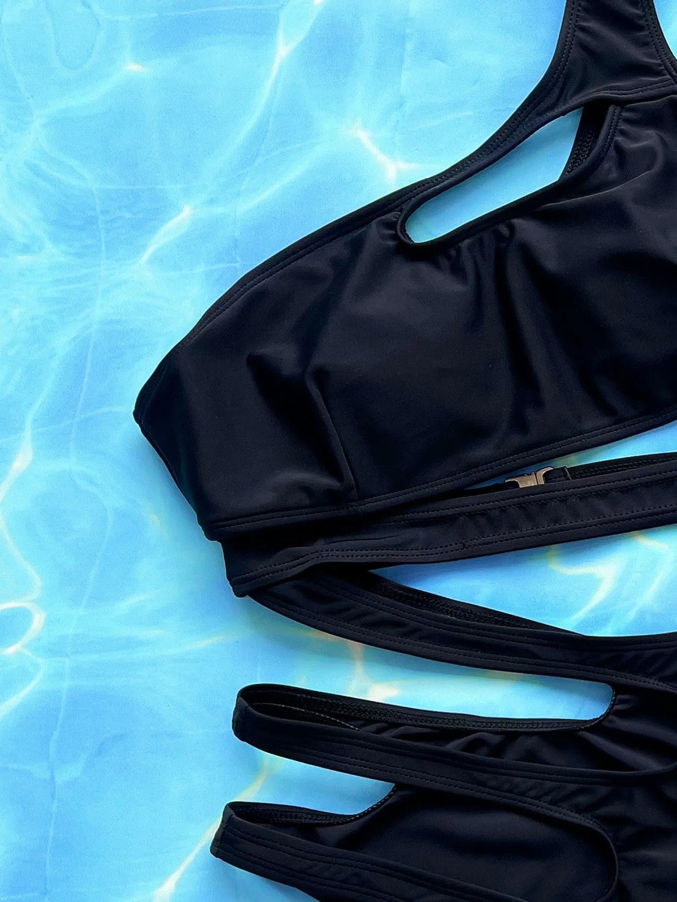 Black women's one-piece swimsuit with hollow out strap detail on the back.