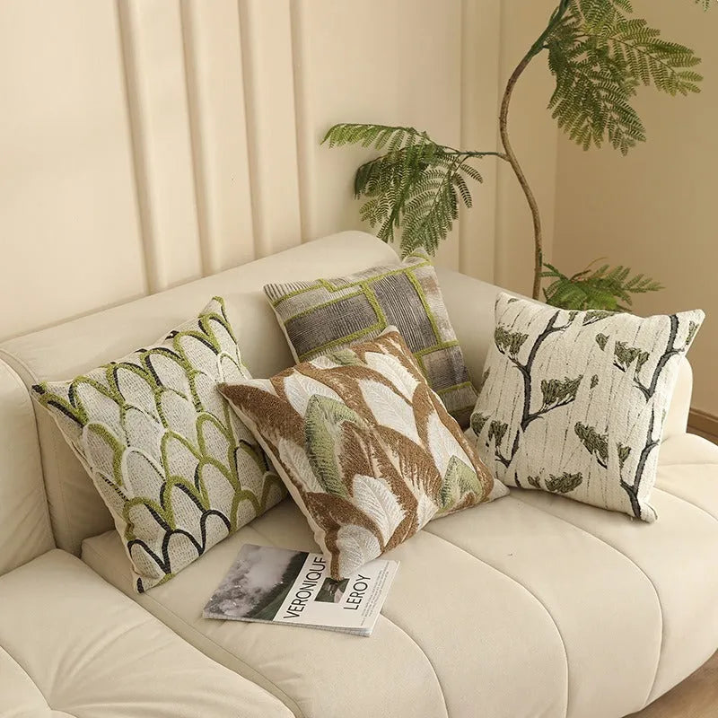 Square jacquard pillow cover with retro botanical pattern, shown in one of eight colour options.