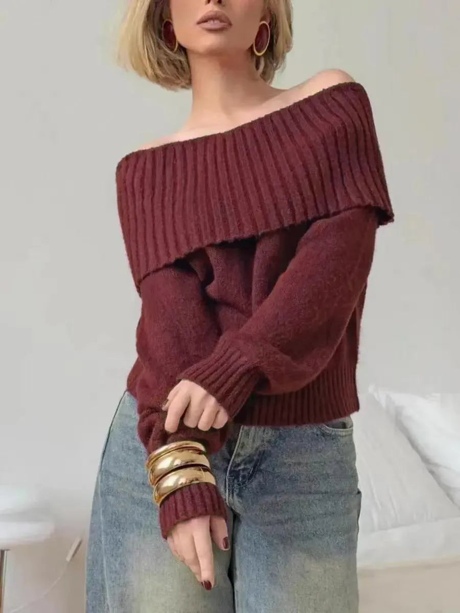 Grey off-the-shoulder women's sweater with a 3D textured pattern.
