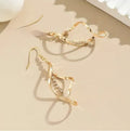 Women's gold geometric earrings with spiral design and diamond shape on alloy construction