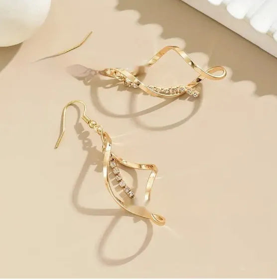 Women's gold geometric earrings with spiral design and diamond shape on alloy construction