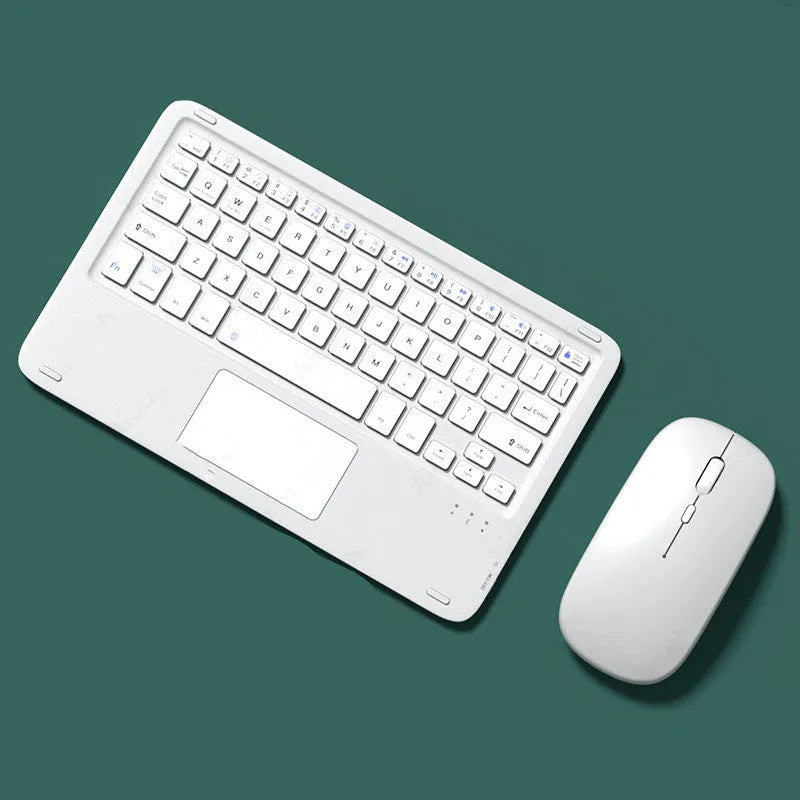 Pink wireless Bluetooth touch keyboard and rechargeable mouse set on a table with charging cable