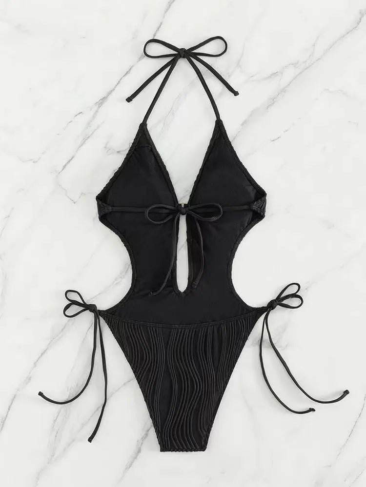 Women's black lace-up triangle bikini swimsuit with adjustable front detailing on mannequin