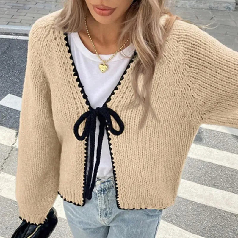 Lace-up cardigan sweater with crocheted flower detailing in solid colour