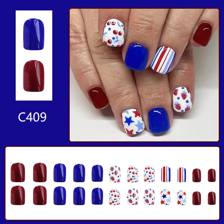 Short glossy false nails with red and blue strawberry cherry pattern, 24 piece set.