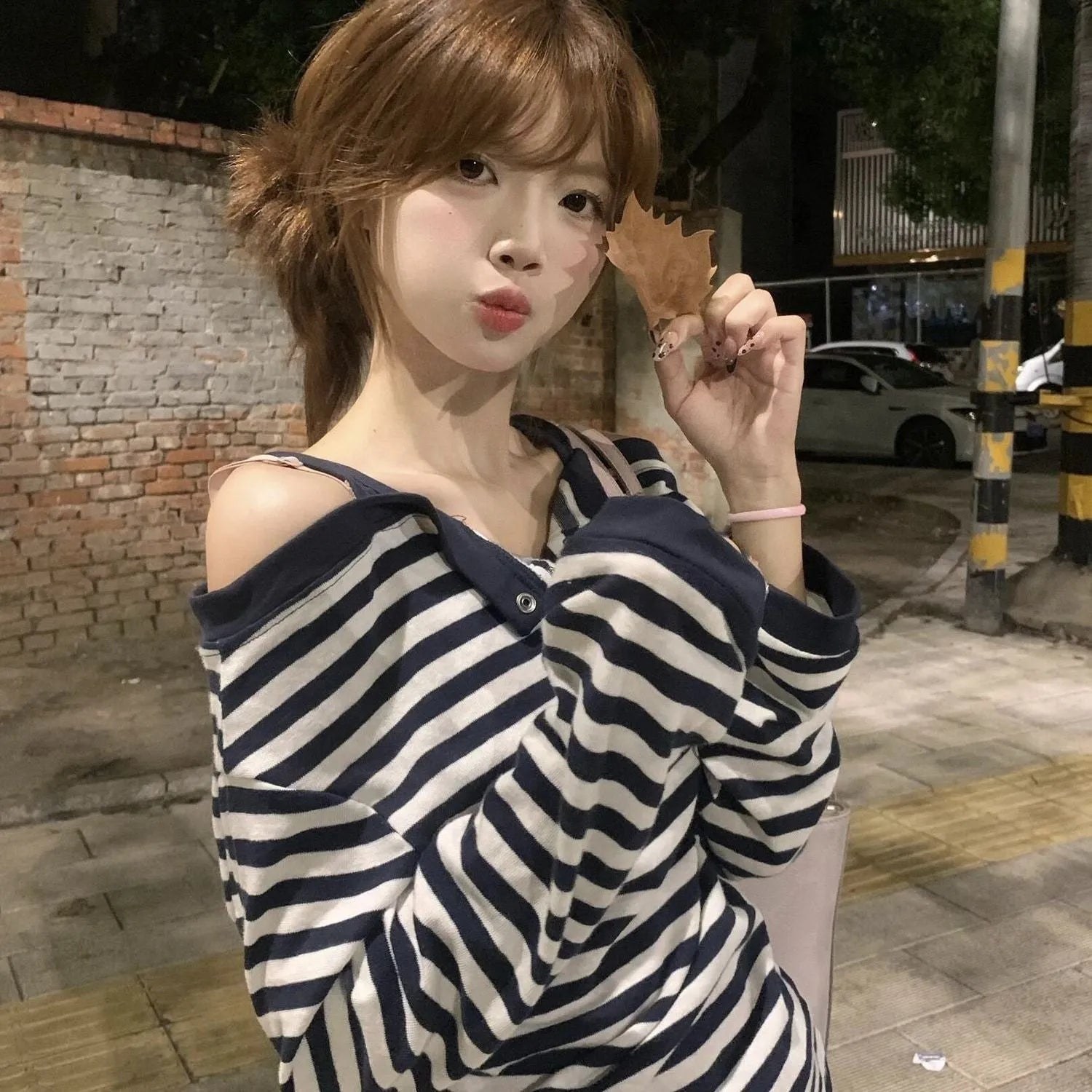 Dark blue oversized long-sleeved women's T-shirt with stripes and embroidery details.