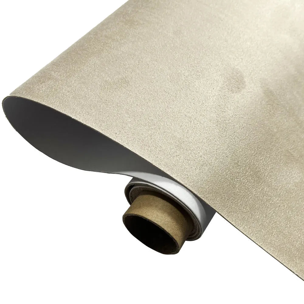 Roll of self-adhesive leather suede fabric in BMW brown colour next to a car dashboard.