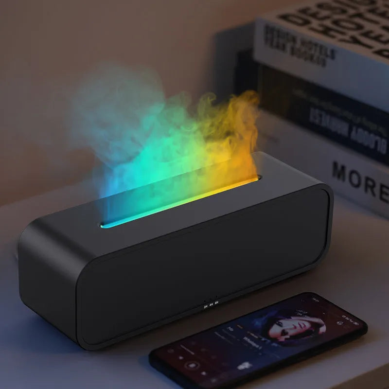 Black and white USB essential oil aromatherapy diffuser with colour-changing lights and remote control on a table