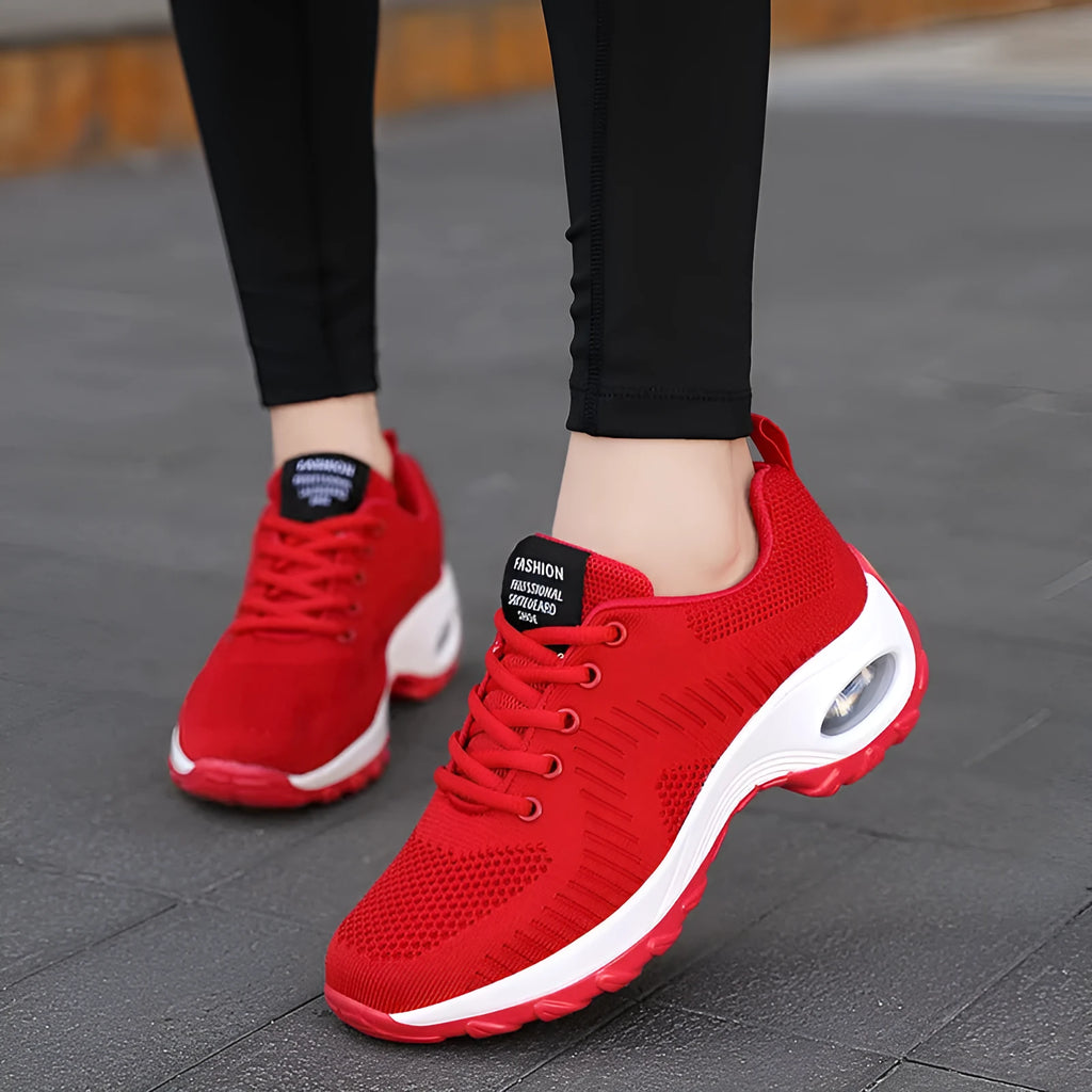 Women's low-top black mesh sneakers with white laces and a 3-5cm heel on a grey background.