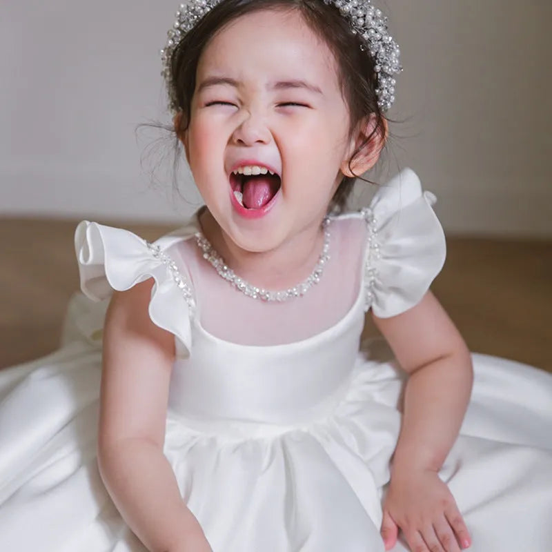 Girls' white satin princess dress with puff sleeves, full-length view, white fabric