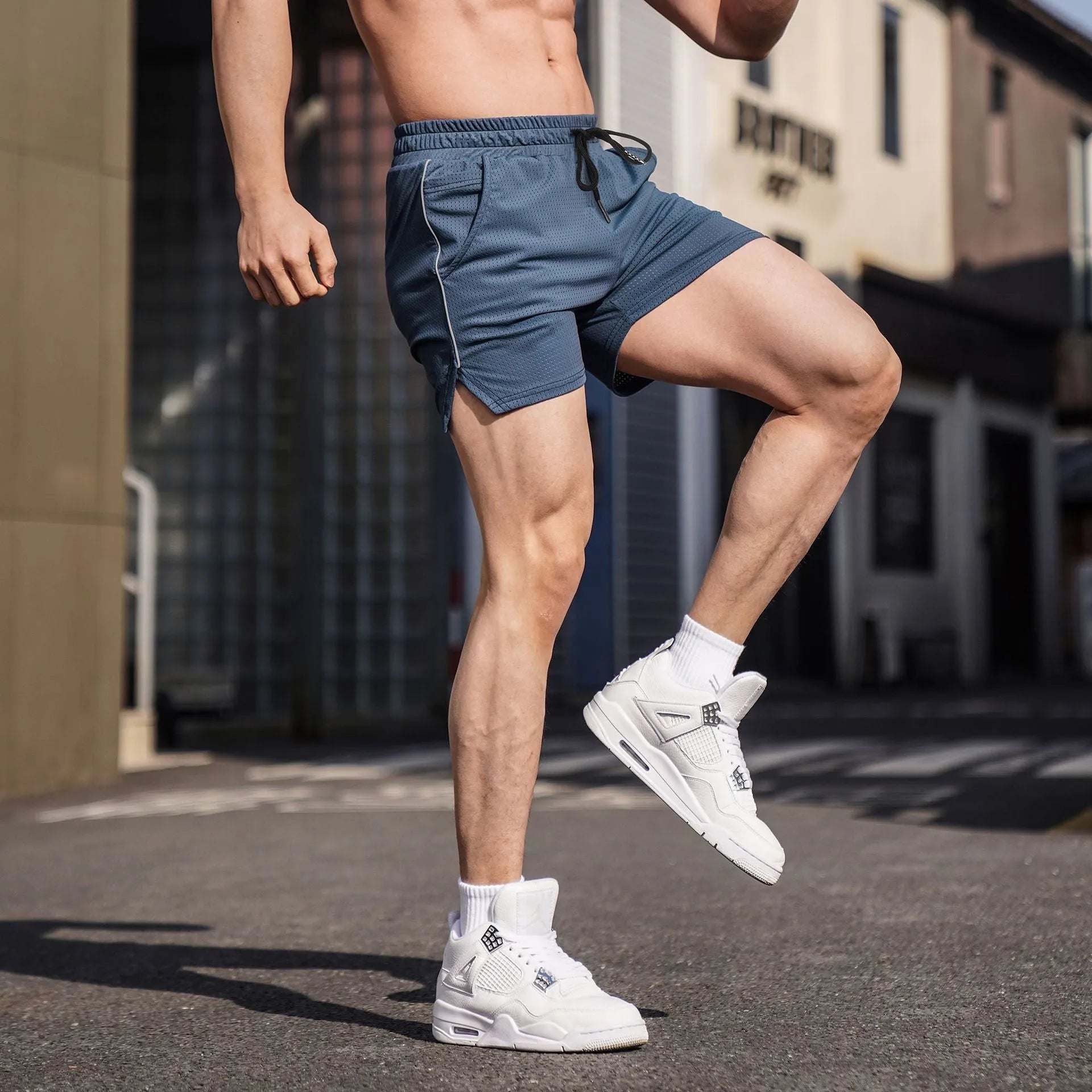 Men's polyester fitness shorts in straight-leg style, showing available colours and shorter athletic length