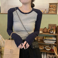 Women's oversized slim fit top with embroidery on the sleeves, shown in dark blue.
