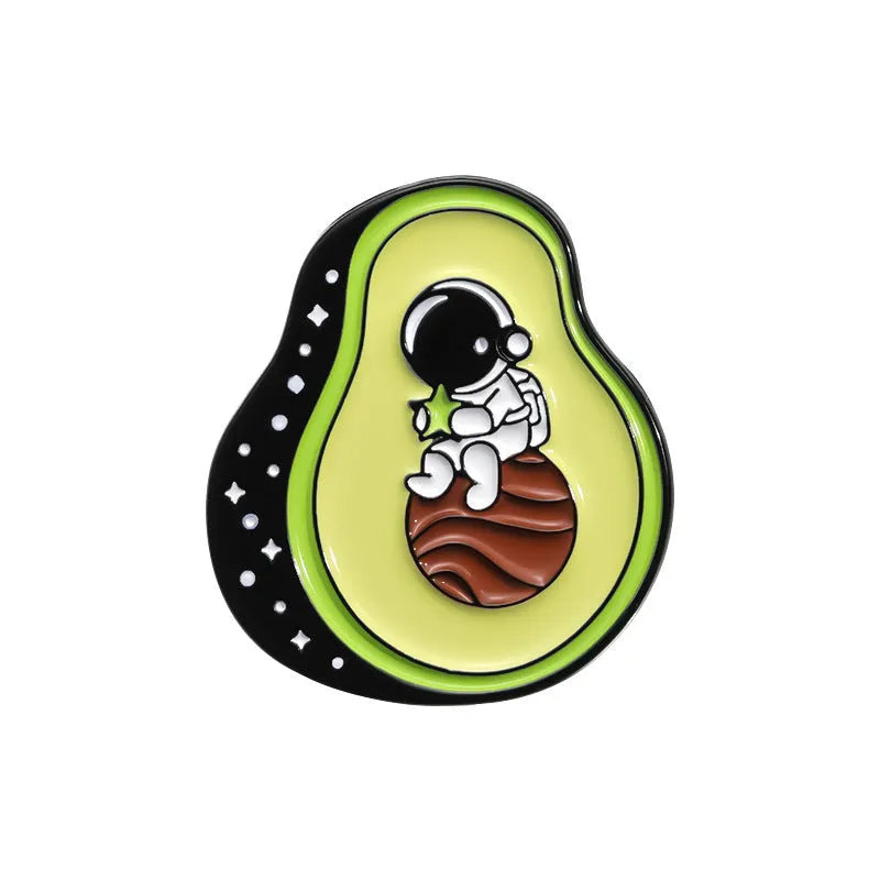 Colourful cartoon-style fruit metal brooch with a pin back on a denim jacket lapel.
