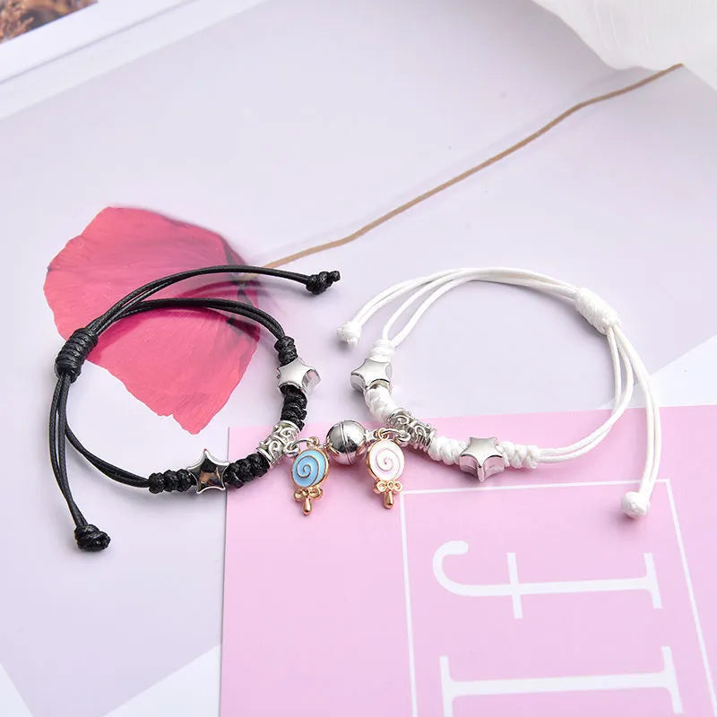 Pair of magnet suction cup bracelets in alloy with electroplated finish, showing seamless clasp and symbolic design.