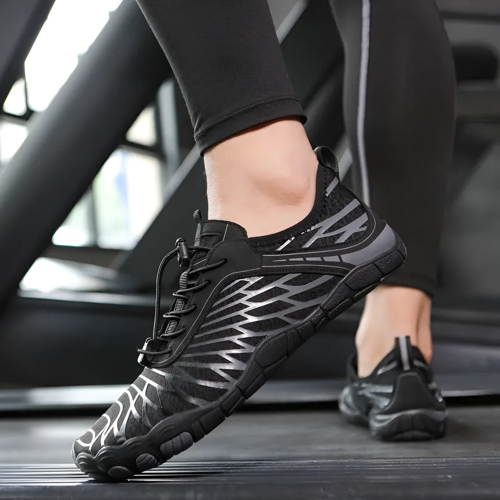Men's white and black lace-up casual sports shoes with a non-slip rubber outsole on a plain background.