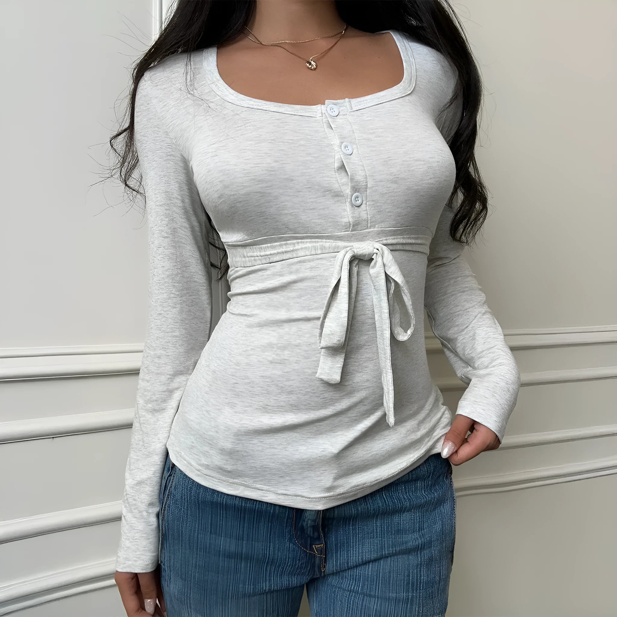 Women's gray slim fit long sleeve base layer t-shirt on model, front view