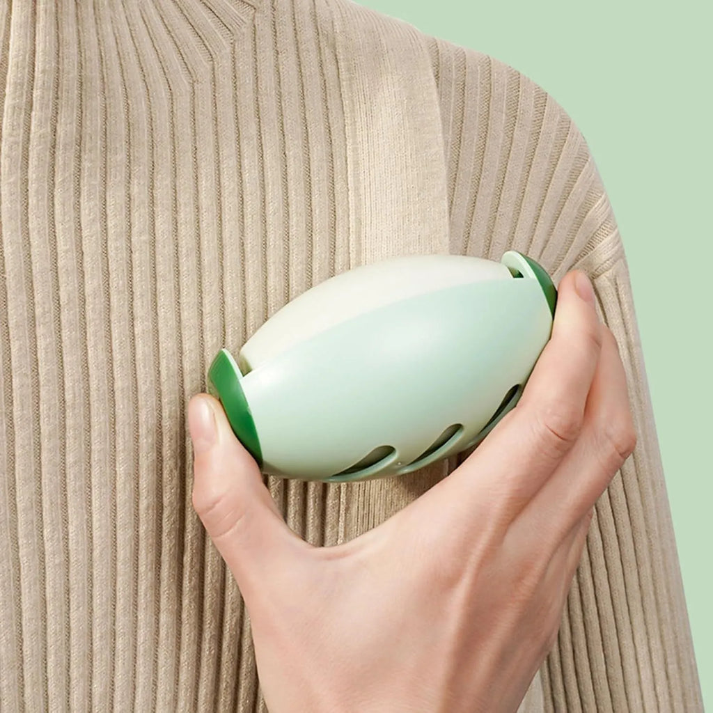 Green and white reusable gel lint roller ball for removing pet hair and lint from clothes.