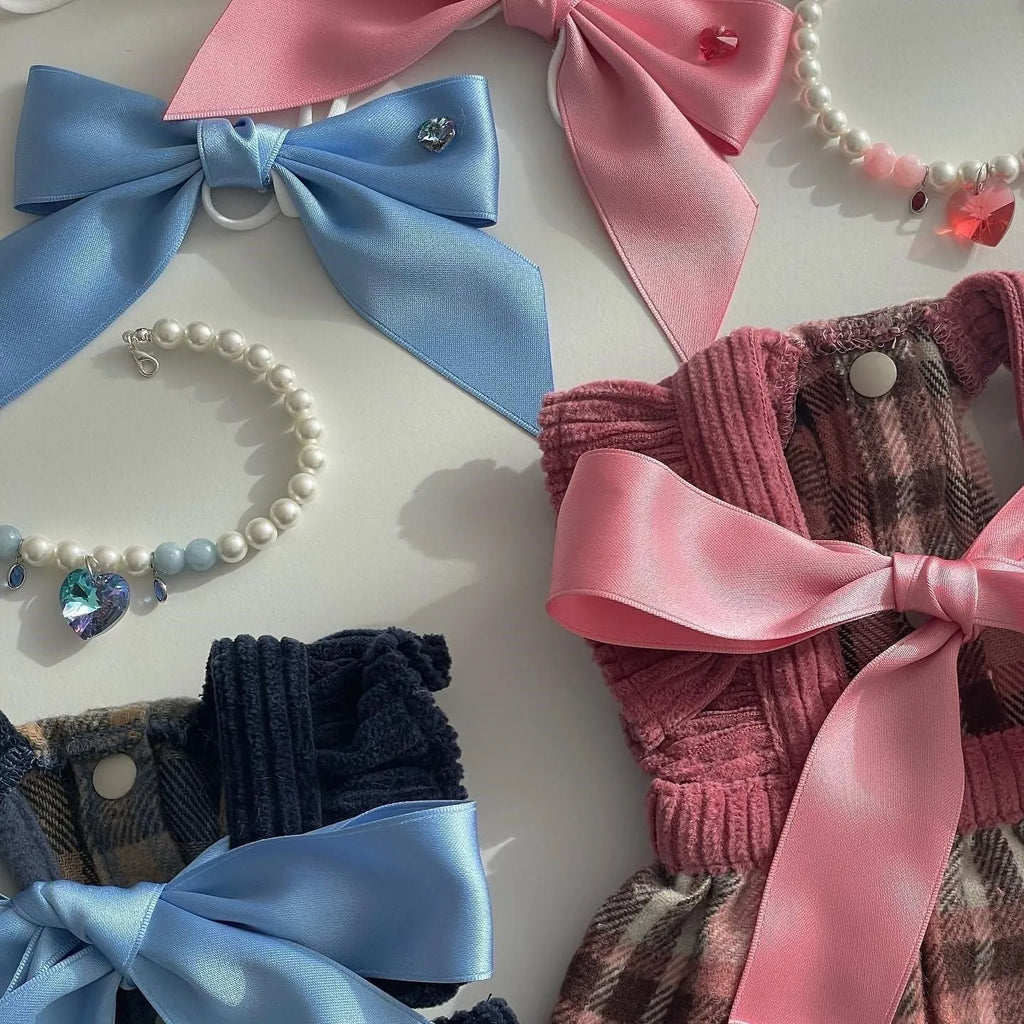 Blue and pink adjustable bow dog headdress hair band on a white background.