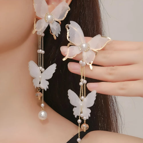 White butterfly earrings with lace design, pearl accents, rhinestones, and tassel on electroplated copper alloy