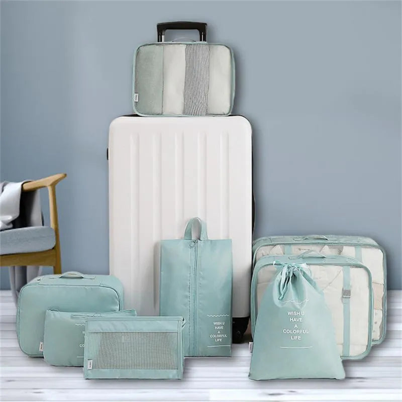 8-piece set of nylon packing cubes in various colours for travel storage of clothes, shoes, and toiletries