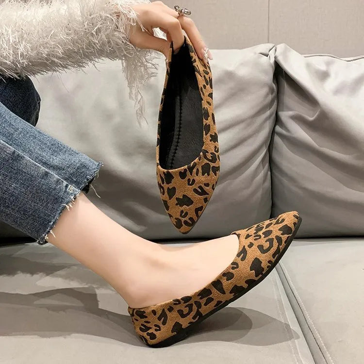 Women's leopard print flat pumps with a pointed toe, low heel, and cotton upper on a rubber sole.