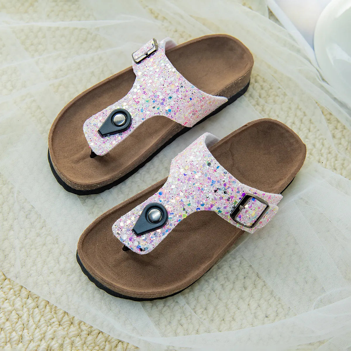 Gold frosted cork flip-flops with artificial leather upper and textured PVC sole.