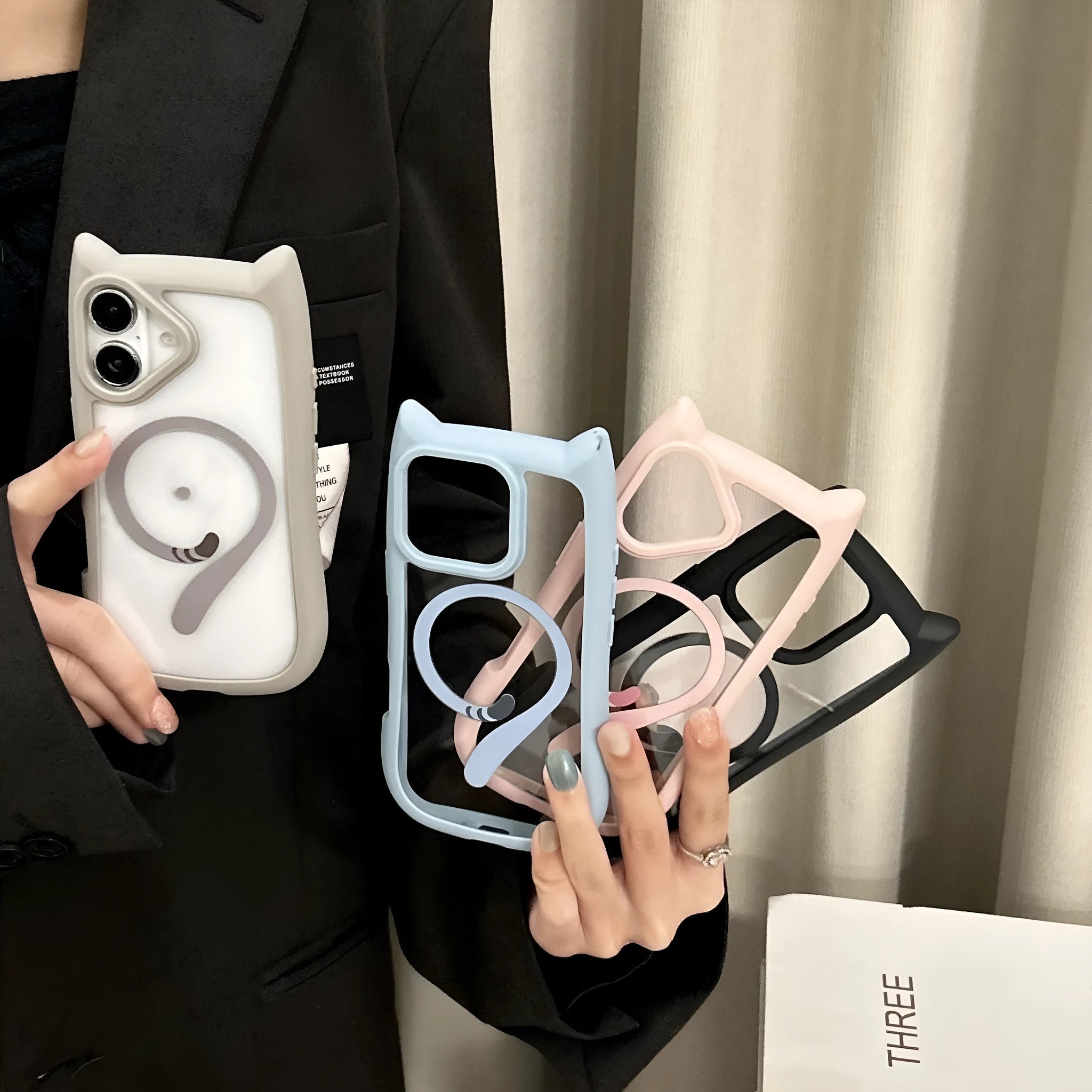Clear acrylic and TPU magnetic phone case for iPhone 17 in black, blue, grey, and pink colours.