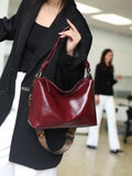 Genuine leather pillow-shaped commuter bag in caramel colour with double straps and patchwork detailing, 31x11x24cm