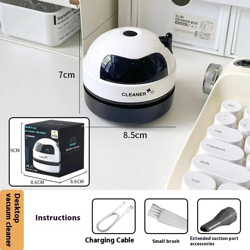USB-powered handheld desktop vacuum cleaner in blue rocket design on a wooden desk.