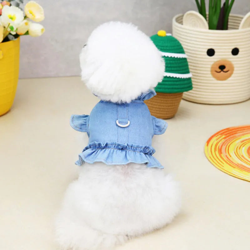 Dark blue denim dog dress with ruffles and a metal leash hook on the chest.