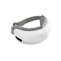 White rechargeable eye massager with hot compress and airbag functions on a table