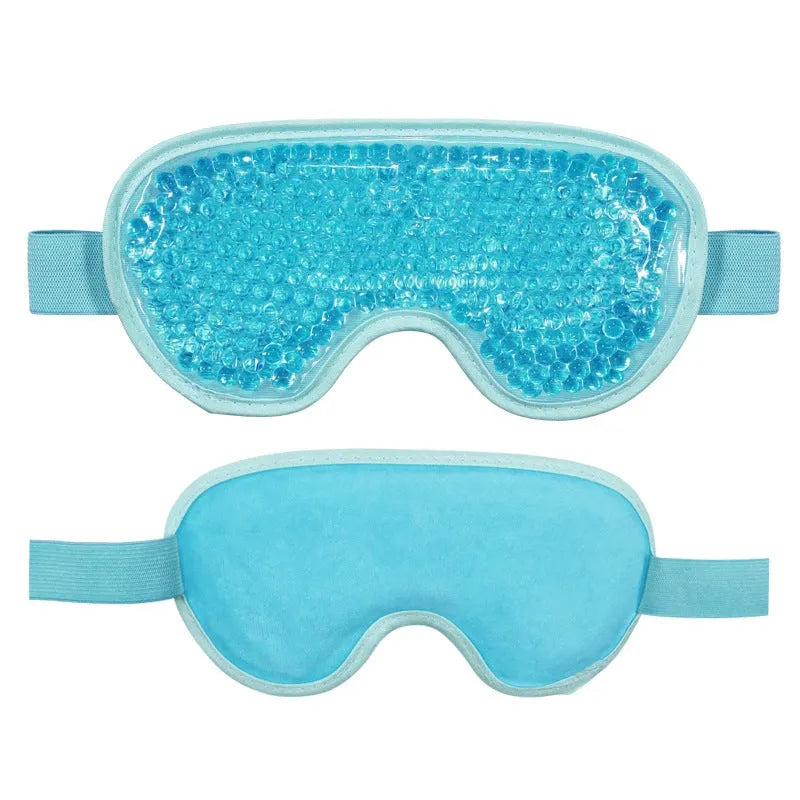White portable rechargeable eye compress and atomisation device with included eye mask on a table.
