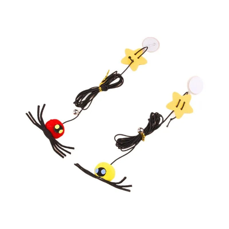 Cat toy with elastic rope hanging over a door, featuring a feather wand, jingle bell, and dangling spider attachment.